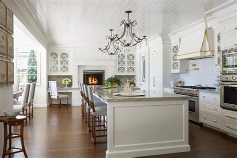 I always wondered why people place their cups upside down in a cupboard. Gourmet Kitchen with Raised White Brick Fireplace - Transitional - Kitchen