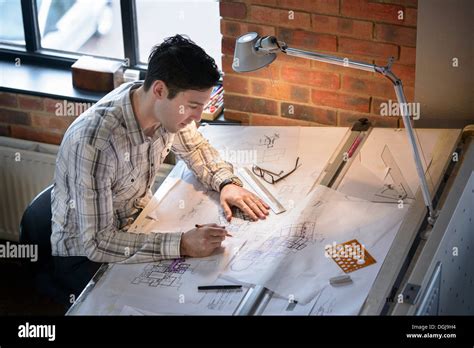Architect Drawing Plans At Drawing Board Stock Photo Alamy
