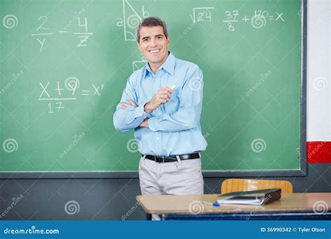 Male Teacher Standing Arms Crossed Against Board Stock Photo Image Of