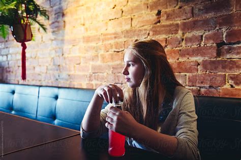 Teenage Girl Sitting At A Table With A Soda By Stocksy Contributor Angela Lumsden Stocksy