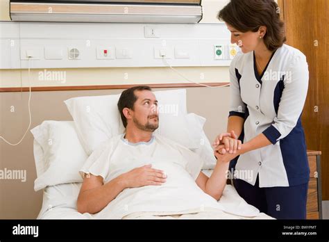 Nurse Comforting Patient In Hospital Room Stock Photo Alamy