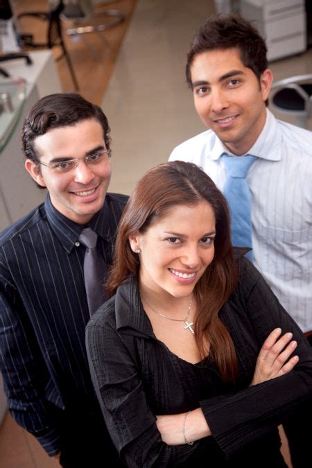 Business Partners Standing At An Office Smiling Freestock Photos