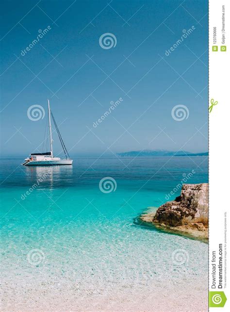Beautiful Azure Blue Lagoon With Sailing Catamaran Yacht Boat At Anchor