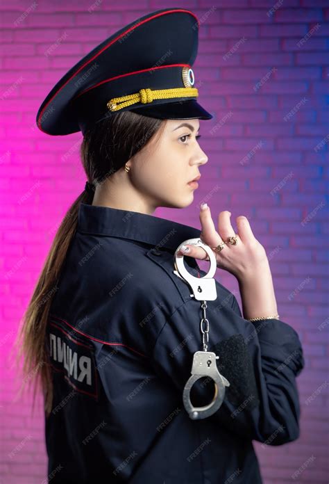 premium photo a woman in a russian police uniform with handcuffs english translation police