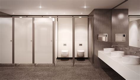 A Bathroom With Two Sinks And Three Urinals