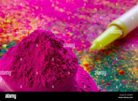 Close Up Of Pink Holi Color Powder With Squirt Gun In Background Stock