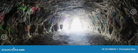 Inside Large Sandstone Cave Walls Covered With Graffiti Stock Image