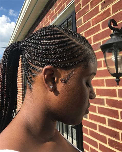 This hairdo also looks very artistic where the hairstylist has put on so much effort and time. 😍 Low Feedin Ponytail * * #feedins #feedincornrows # ...