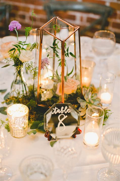 Your guests will be spending quite a bit of their time in close proximity to the tables throughout your reception venue, so you should ensure they are well decorated for the special occasion. Gold Terrarium Centerpiece with Mirror Table Numbers