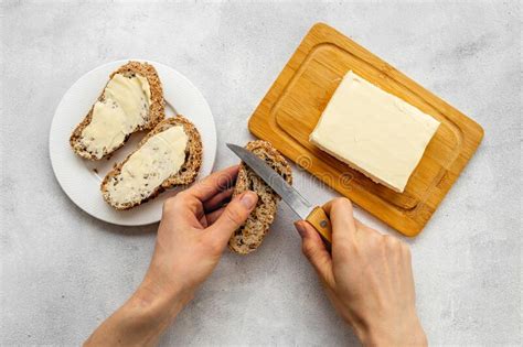 Hands Spreading Butter With Knife On Toast Bread Top View Stock Image