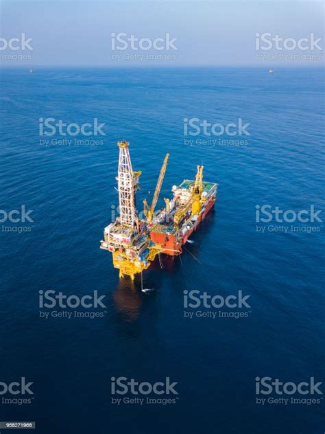 Aerial View Of Tender Drilling Oil Rig In The Middle Of The Ocean Stock