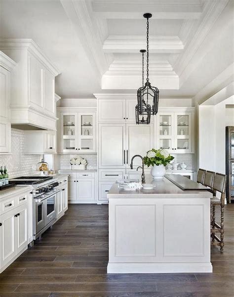 A Large Kitchen With White Cabinets And An Island
