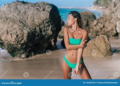 Beautiful Tanned Woman In Separate Swimsuit Posing On Beach And Looking