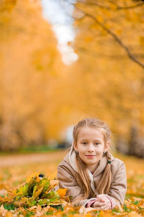 Portrait Of Adorable Little Girl Outdoors At Beautiful Warm Day With
