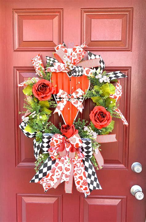 A Red Door With A Heart Shaped Wreath On It