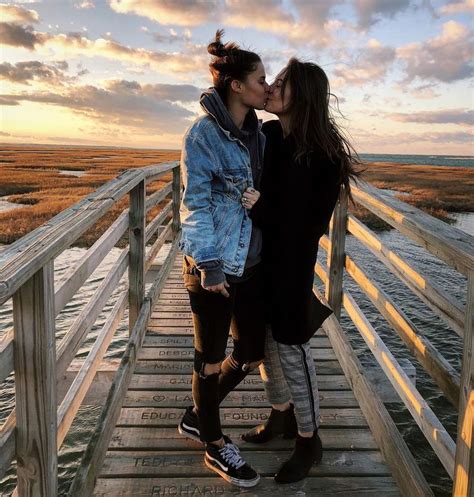 cute lesbian couple kissing at sunset