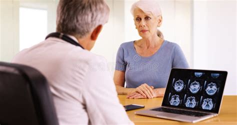 Older Woman Talking With Personal Doctor About Her Health Concerns