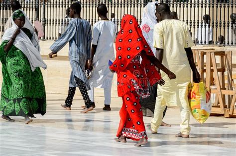 Unidentified Senegalese Woman In Colored Traditional Clothes Wa