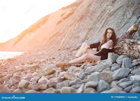 Dreamy Lonely Brunette Hippie In The Style Of Bokho Chic Sits On Gray