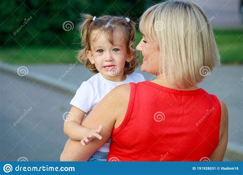 beautiful blonde mom in a red t shirt with her daughter group portrait stock image image of