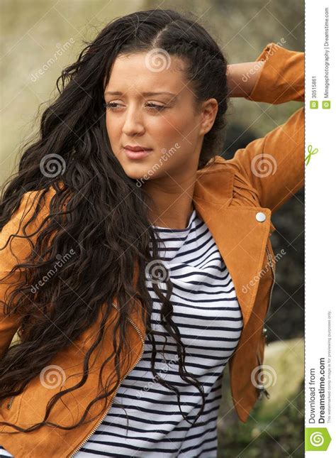 Portrait Of A Woman With Long Black Hair Posing Outdoors Stock Image