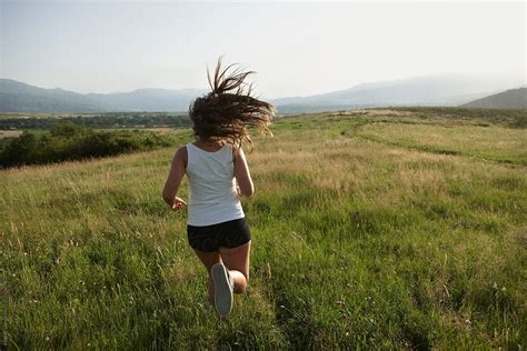 Young Girl With Long Hair Motion Running Through The Fields Del