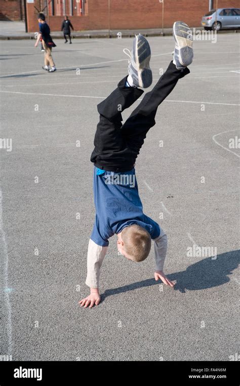 Young Boy Doing Handstand In School Playground Stock Photo Alamy