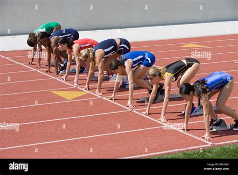 Female Athletes In Starting Blocks Ready To Run Stock Photo Alamy