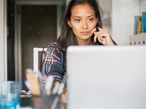 Young Woman Focused On Her Laptop While Working From Home By Jovo Jovanovic