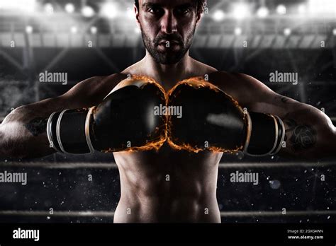 Determined And Confident Boxer With Fiery Boxing Gloves Stock Photo Alamy