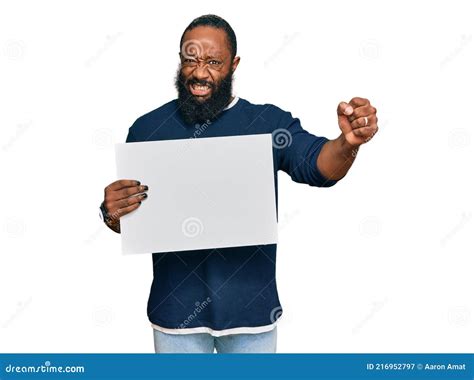 Young African American Man Holding Blank Empty Banner Annoyed And