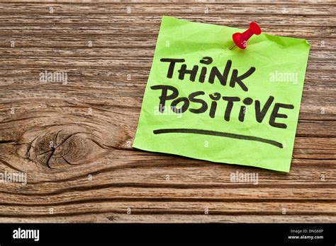 Think Positive Reminder Note Against Grained Weathered Wood Stock Photo