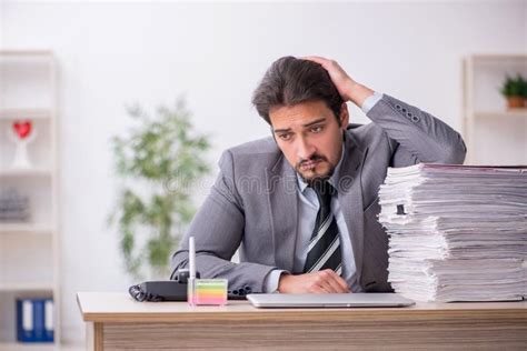 Young Male Employee And Too Much Work In The Office Stock Photo Image