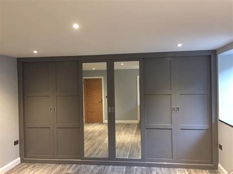 A Gorgeous Fitted Wardrobe With Sliding Doors And Mirrored Panels