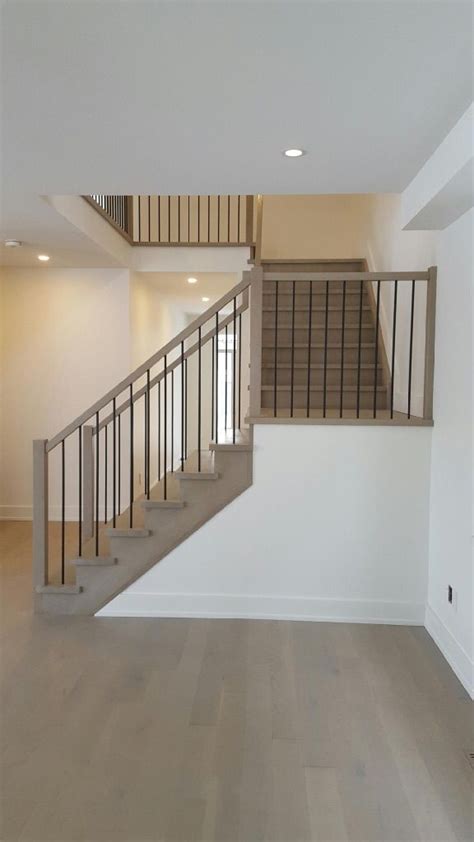 Plowed handrail is designed to accept the square tops of wood balusters. White Oak stair constructed with closed risers, closed ...