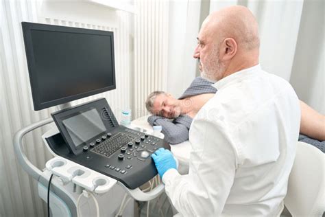 Ultrasound Specialist Is Looking To The Screen Of Medical Device Is