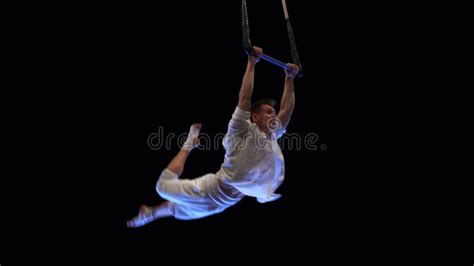 Muscular Male Aerial Circus Artist Performances With Dance Trapeze