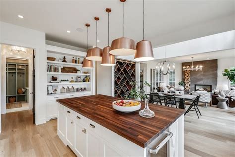 Clean White Cabinets With Copper Lighting Accents By Trickle Creek