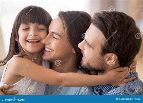 Cute Little Girl Hug Mom And Dad Showing Love Stock Photo Image Of