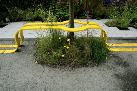 Yellow Street Lines Form A Park Bench Around A Tree In This Temporary
