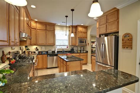 Tendencies in kitchen inclinations and house design led to a smaller amount of cabinets, major appliances that were bigger plus smaller kitchens. spacious modern kitchen with maple cabinets and granite ...