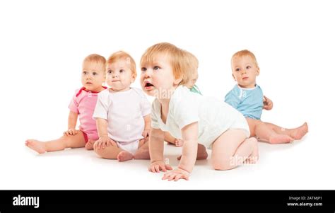 Group Of Cute Babies Crawling On Floor Isolated On White Stock Photo