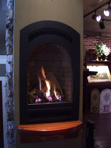 A Fire Burning Inside Of A Fireplace In A Living Room