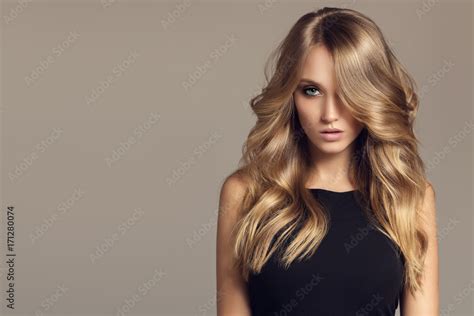 Blond Woman With Long Curly Beautiful Hair Stock Photo Adobe Stock