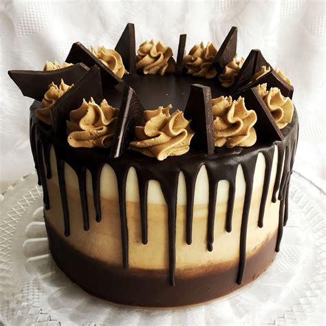 Hot water, unsweetened cocoa powder, milk chocolate chips, heavy whipping cream and granulated sugar. Mocha drip cake. Made with dark chocolate cake with coffee buttercream filling. On the outs ...