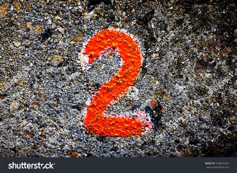 Number Two On The Stone Wall Painted With Paint Stock Photo 248810260