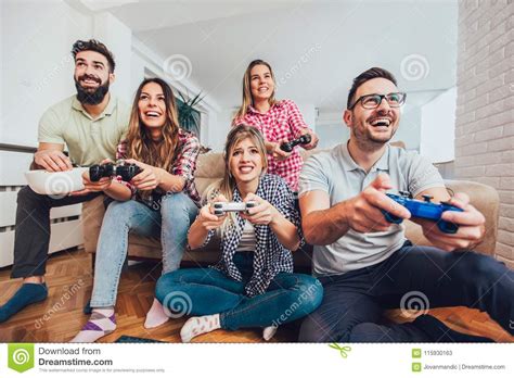 Group Of Friends Play Video Games Together At Home Stock Image Image