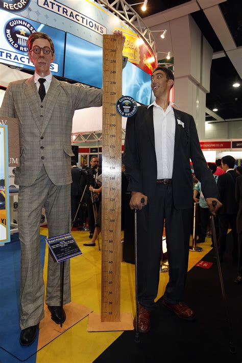 Two Tallest Men In The World Standing Next To A 60 Tall Guy Tall
