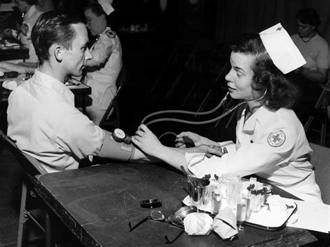 Nurse Taking Mans Blood Pressure Circa 1960 Photograph By Mark Goebel