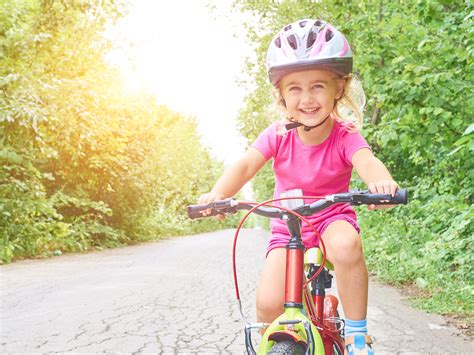 Happy Child Riding A Bike In Outdoor Shaping Outcomes